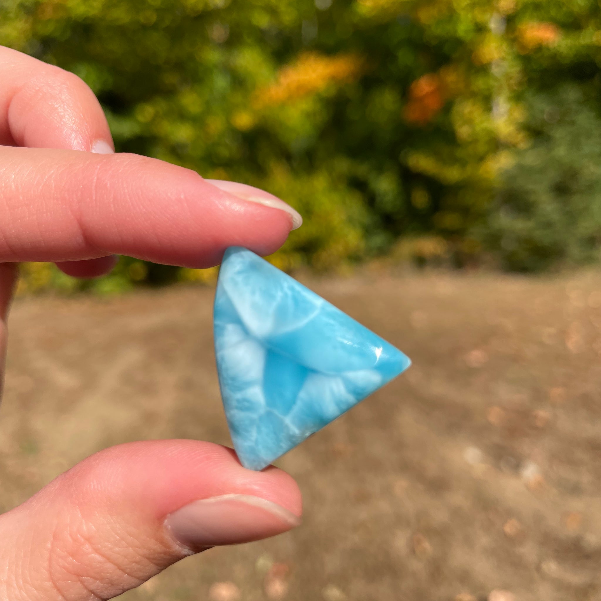 Super blue with soft white lines, shark tooth in shape with polished surface. It has effects on four of the seven Chakras