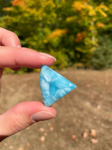 Super blue with soft white lines, shark tooth in shape with polished surface. It has effects on four of the seven Chakras