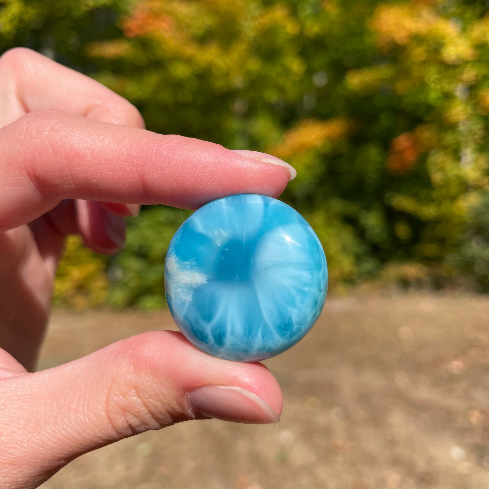 Super blue with soft white lines, round in shape with polished surface. It has effects on four of the seven Chakras