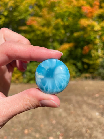 Super blue with soft white lines, round in shape with polished surface. It has effects on four of the seven Chakras