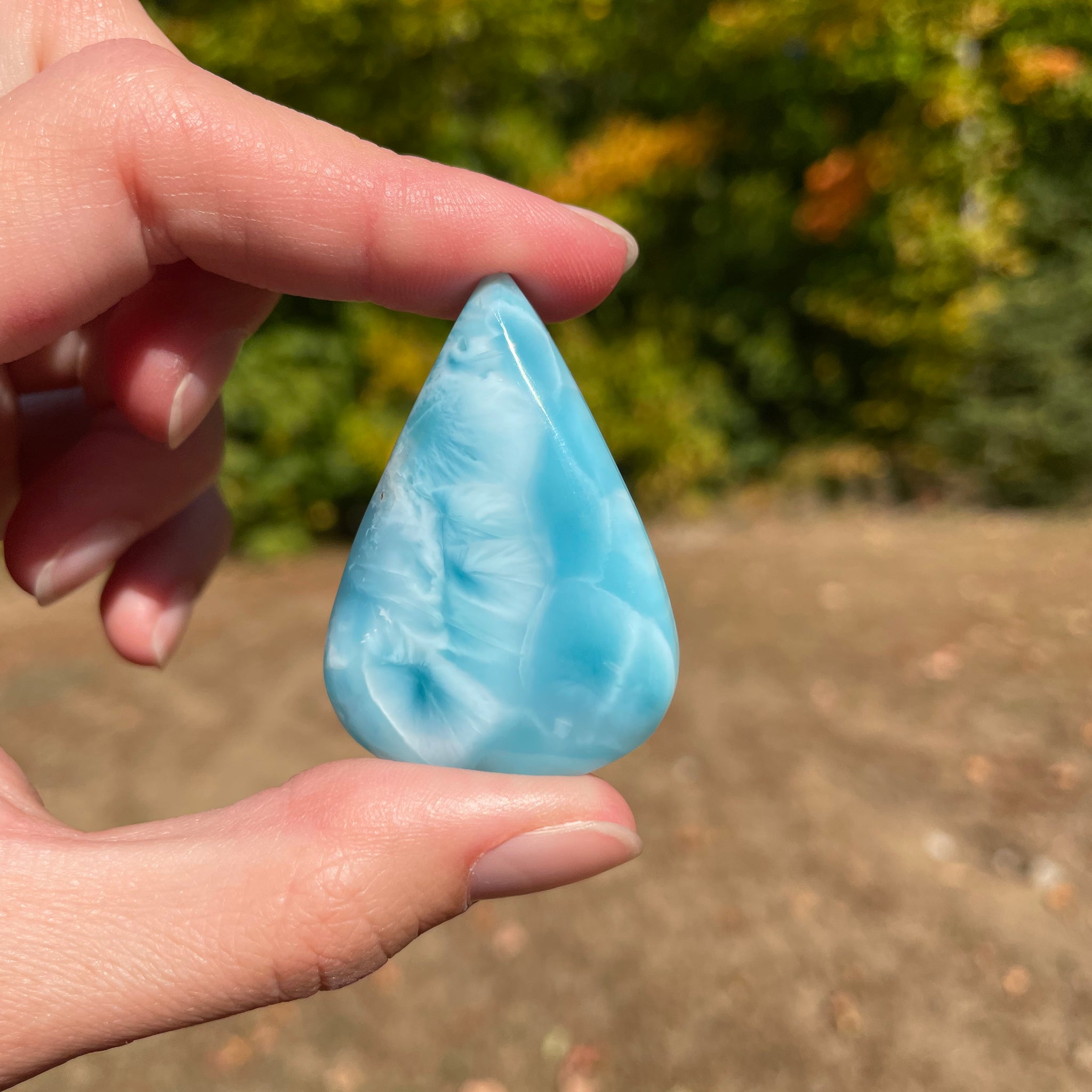 Super blue with soft white lines, tear drop in shape with polished surface. It has effects on four of the seven Chakras