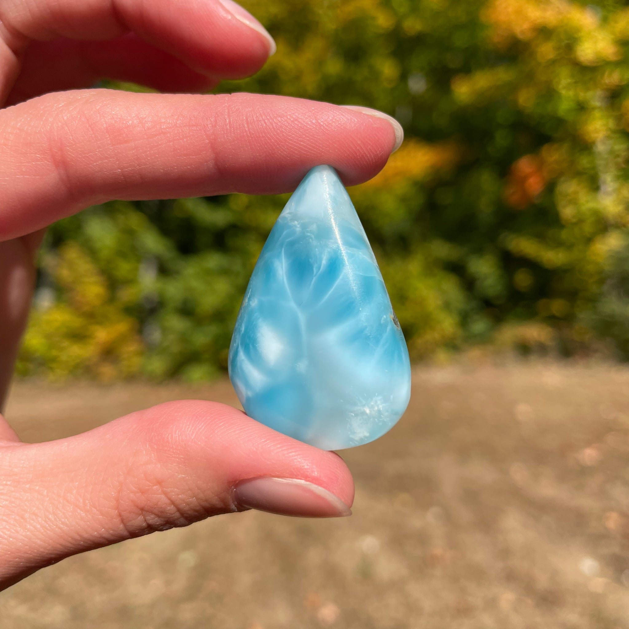 Light blue with soft white lines, tear drop in shape with polished surface. It has effects on four of the seven Chakras