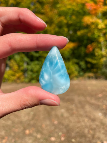 Light blue with soft white lines, tear drop in shape with polished surface. It has effects on four of the seven Chakras