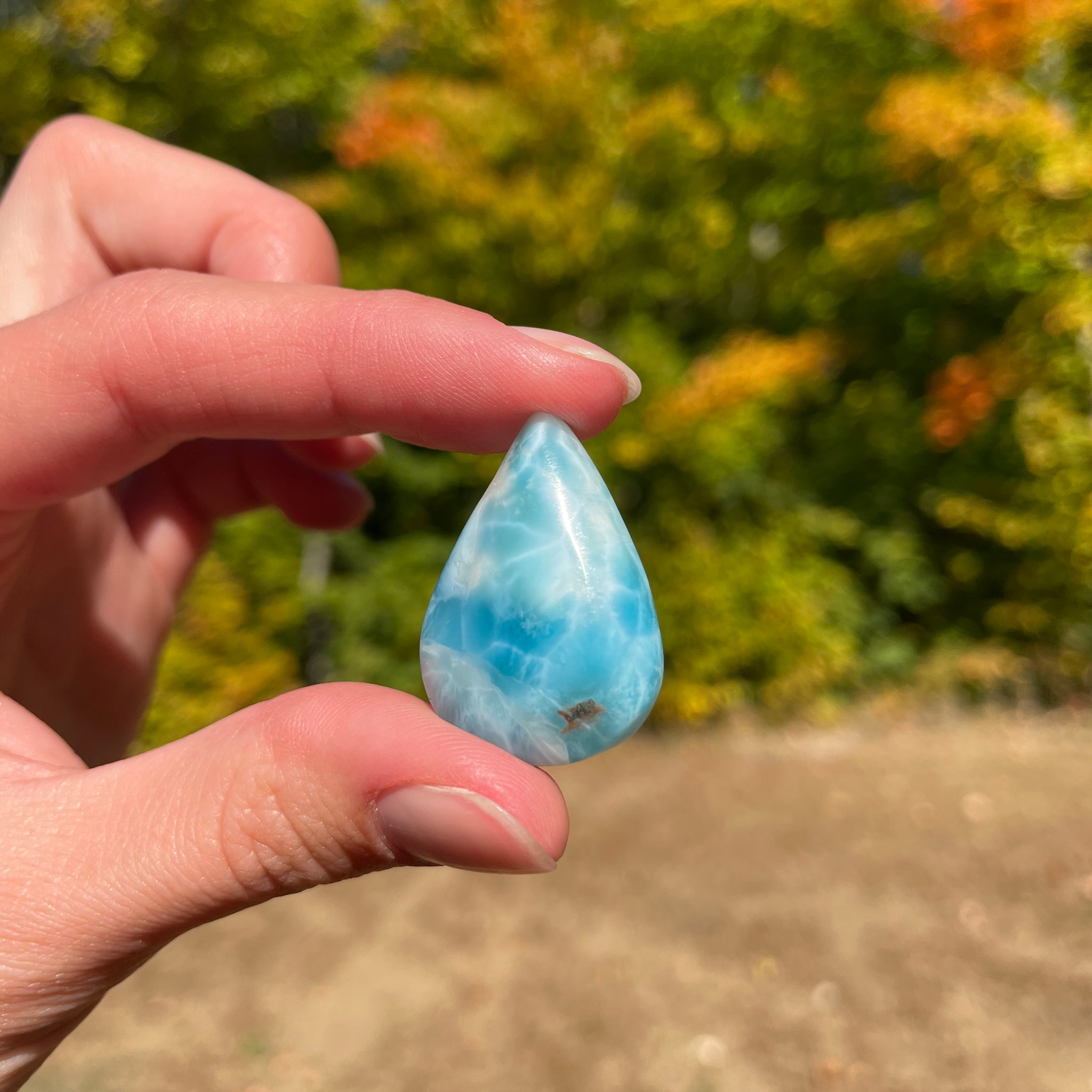 Light blue with soft white lines, tear drop in shape with polished surface. It has effects on four of the seven Chakras