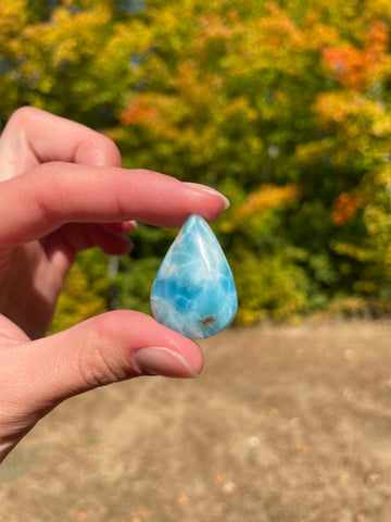 Light blue with soft white lines, tear drop in shape with polished surface. It has effects on four of the seven Chakras