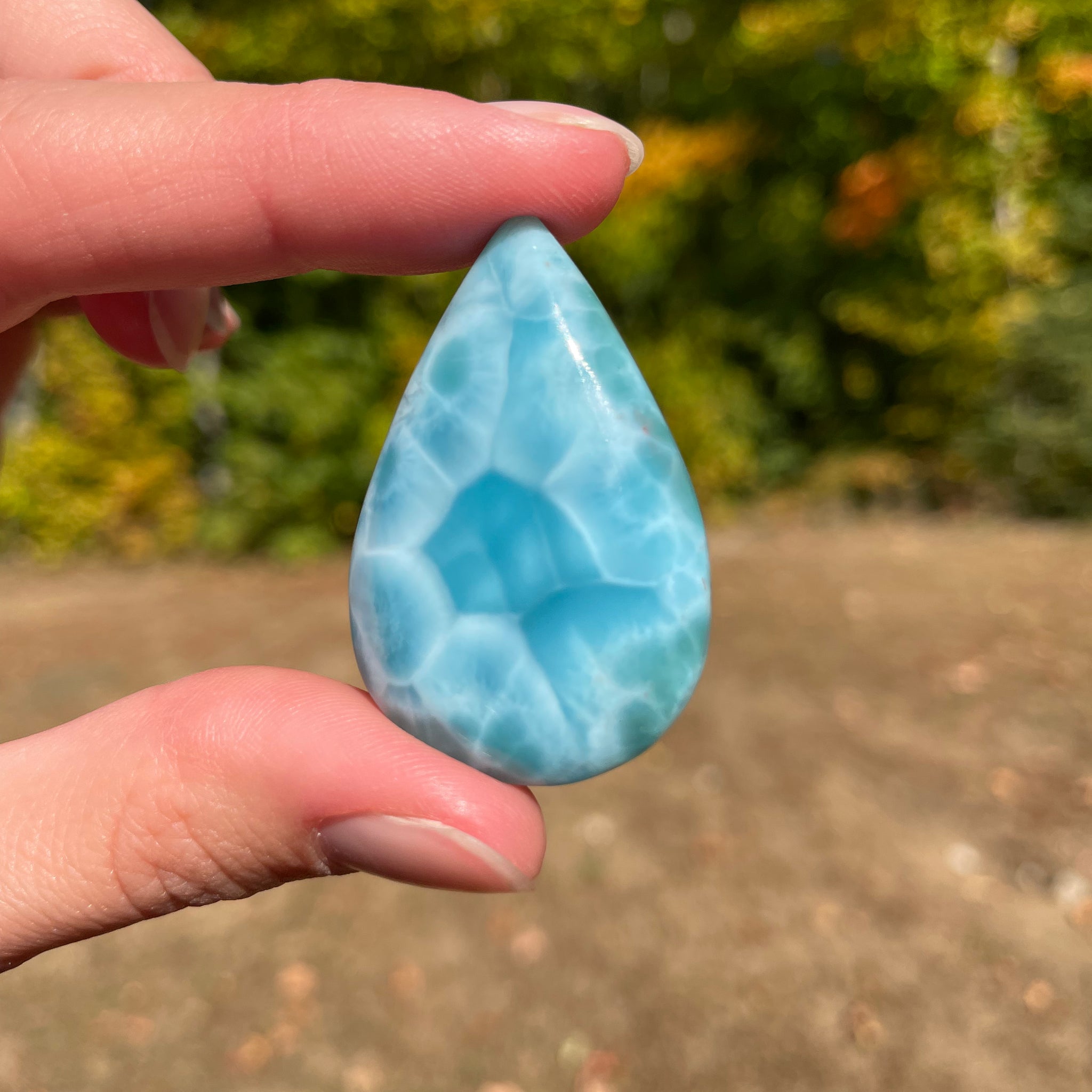 Light blue with soft white lines, Tear drop in shape with beautiful Turtle back effect, with polished surface. It has effects on four of the seven Chakras.