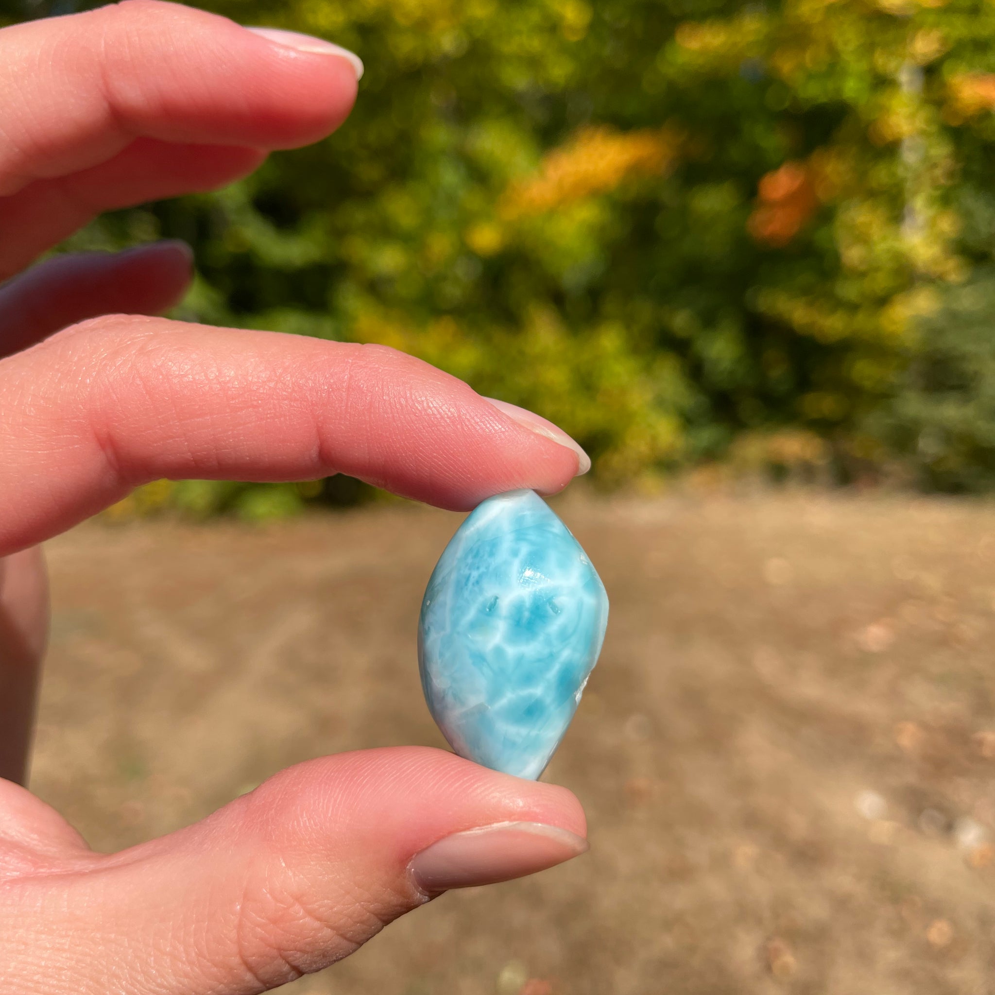 Light blue with soft white lines, tear drop in shape with polished surface. It has effects on four of the seven Chakras