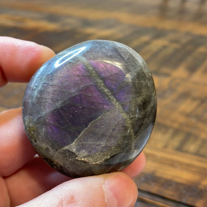 Labradorite palm stones featuring a captivating spectrum of pink, purple, green, gold and orange hues, enhanced by rainbow flashes for a unique vibrant crystal experience. 