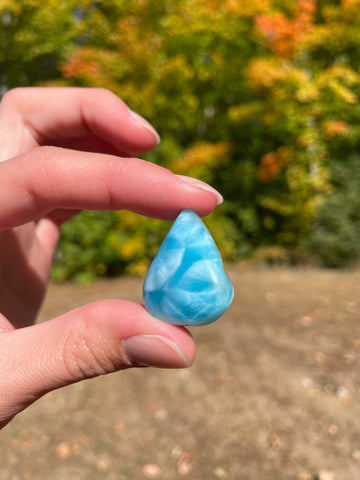 Super blue with soft white lines, tear drop in shape with polished surface. It has effects on four of the seven Chakras