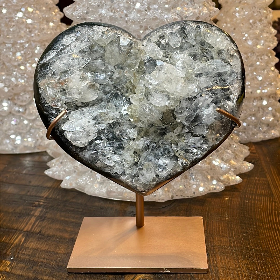 Pink Amethyst druzy hearts on custom metal stands, adorned with transparent crystals and a subtle hue of purple, creating a captivating fusion of elegance and enchantment.