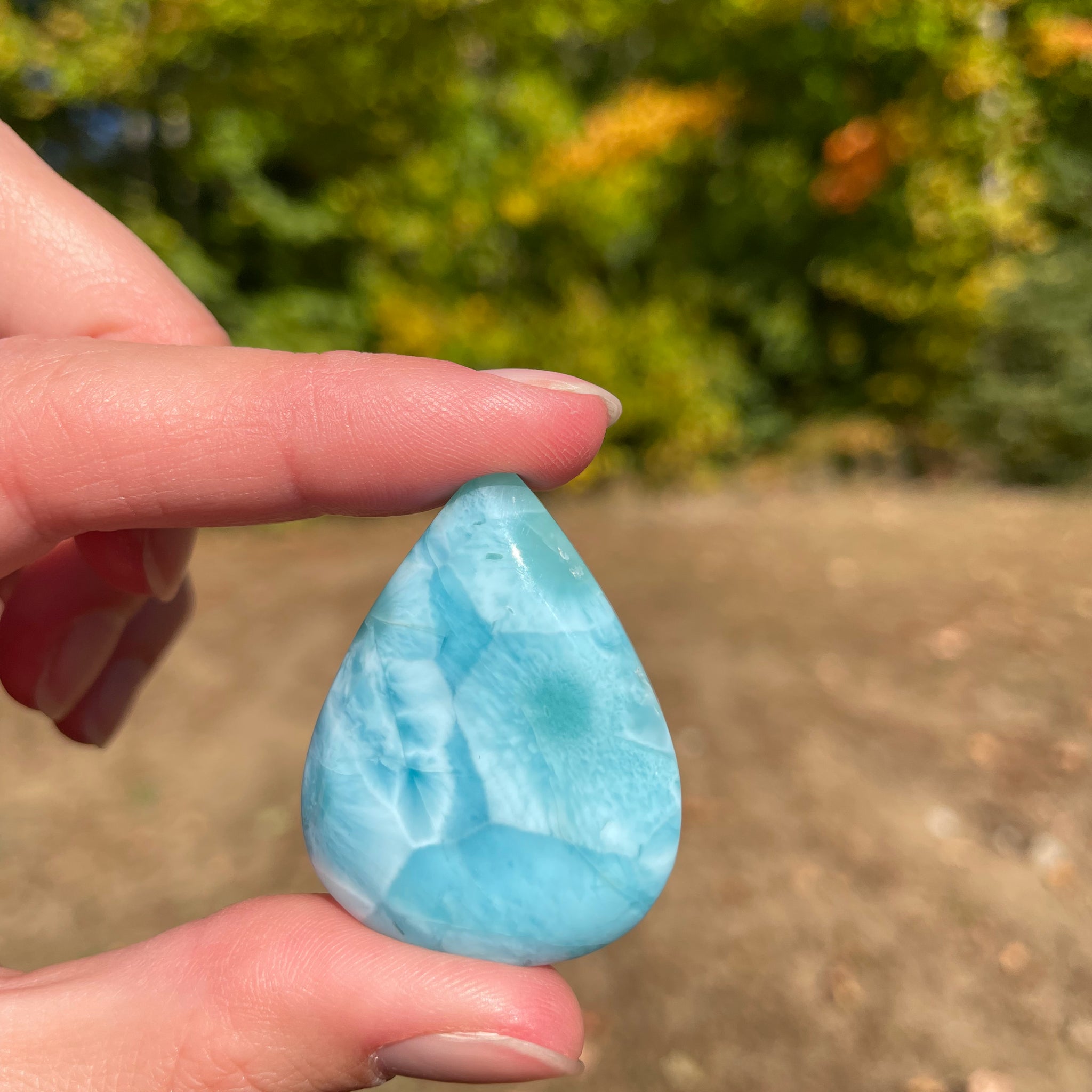 Light blue with soft white lines, Tear drop in shape, with polished surface. It has effects on four of the seven Chakras.