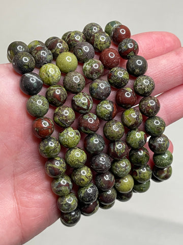 African Bloodstone bracelet with 8mm beads, showcasing the rich green base with distinctive red patterns, capturing the unique bold character of African Bloodstone. This bracelet combines natural beauty with a touch of intensity, making it a striking accessory for various occasions. 