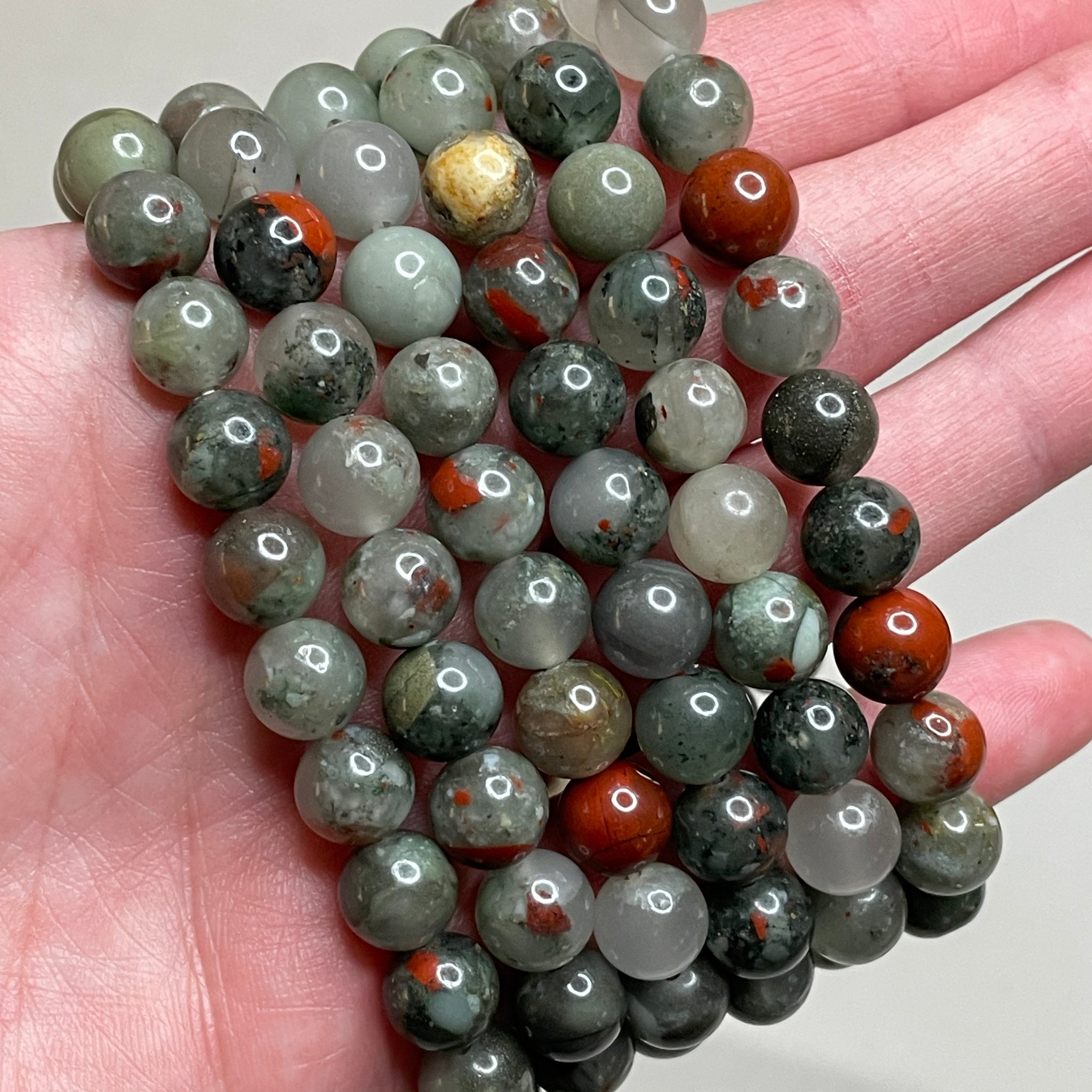 Bloodstone bracelet featuring 8mm beads, displaying the deep green hues with distinctive red specks, capturing the unique beauty of bloodstone. This bracelet combines earthy elegance with a touch of boldness, making it a striking accessory for various occasions.