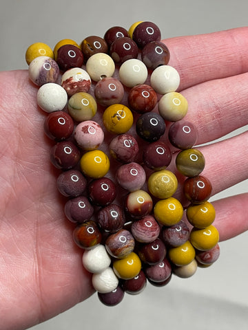 Mookaite Jasper bracelet with 8mm beads, displaying the warm and earthy tones of Mookaite Jasper crystals. This bracelet combines natural beauty with a grounding aesthetic, making it a stylish and calming accessory for various occasions.
