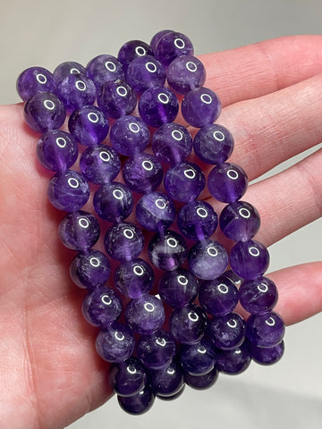 Dark Amethyst bracelet featuring 8mm beads, highlighting the rich and deep purple tones of Amethyst crystals. This bracelet exudes a sense of sophistication and spiritual elegance, making it a striking accessory for various occasions.  