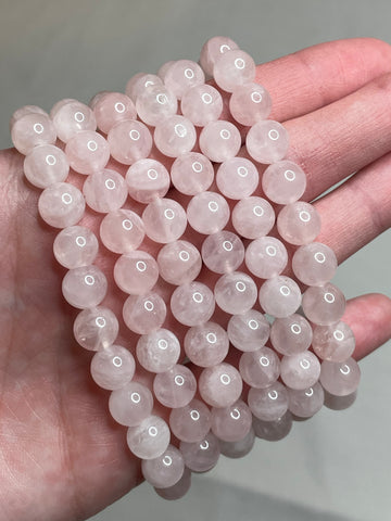 Madagascar Rose Quartz bracelet with 8mm beads, highlighting the soft and delicate pink tones of Rose Quartz crystals. This bracelet combines natural  elegance with a touch of romance, making it a charming accessory for various occasions.