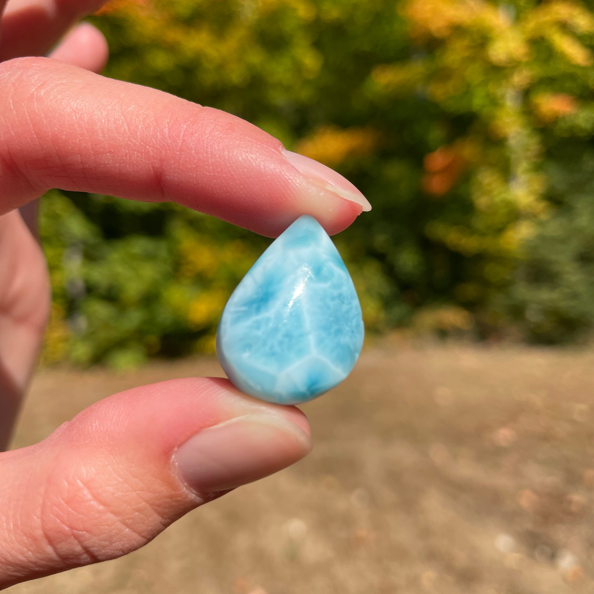 Light blue with soft white lines, tear drop in shape with polished surface. It has effects on four of the seven Chakras
