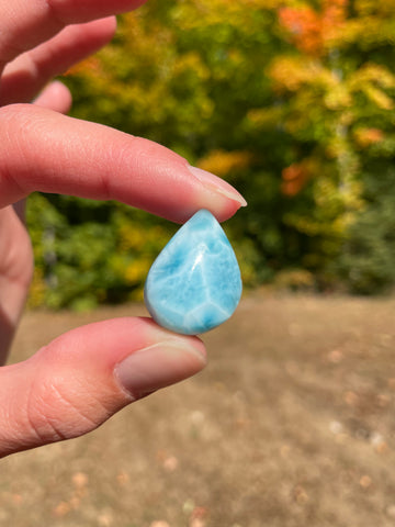 Light blue with soft white lines, tear drop in shape with polished surface. It has effects on four of the seven Chakras