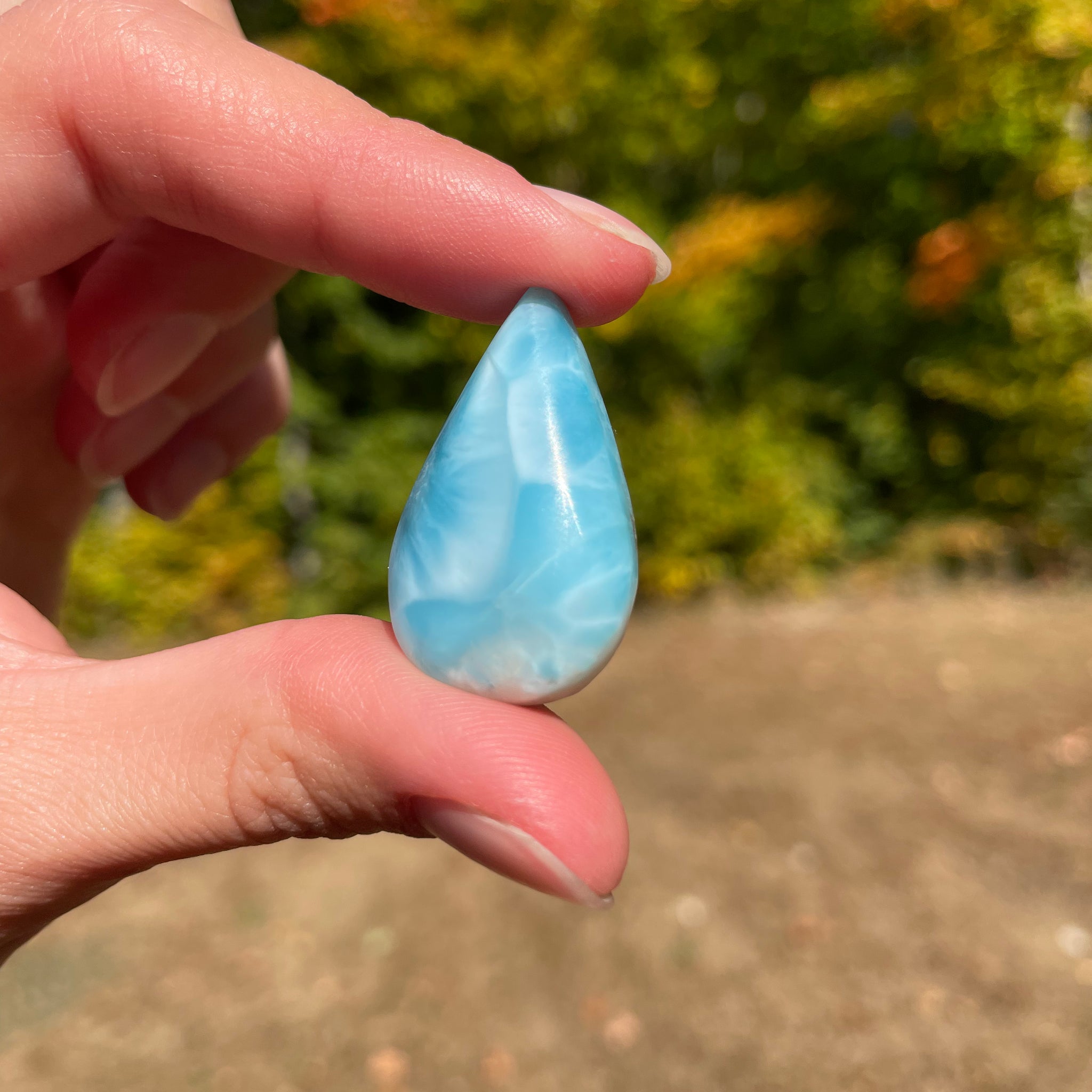 Light blue with soft white lines, Tear drop in shape, with polished surface. It has effects on four of the seven Chakras.