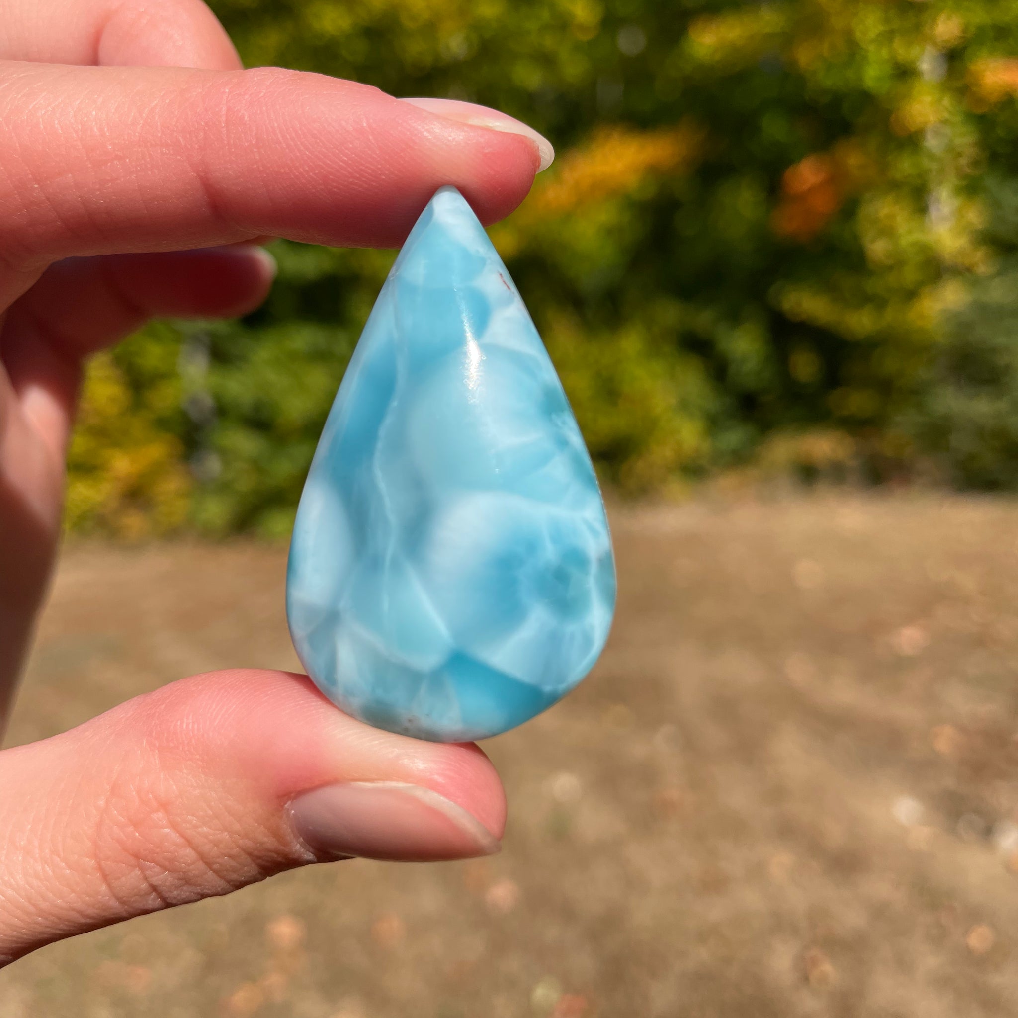 Light blue with soft white lines, Tear drop in shape, with polished surface. It has effects on four of the seven Chakras.