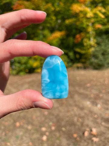 Super blue with soft white lines, oval top and flat bottom in shape with polished surface. It has effects on four of the seven Chakras