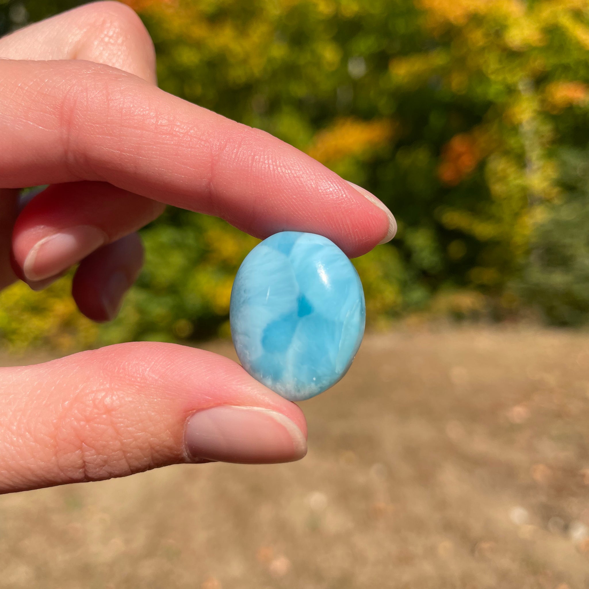 Light blue with soft white lines, round in shape with polished surface. It has effects on four of the seven Chakras