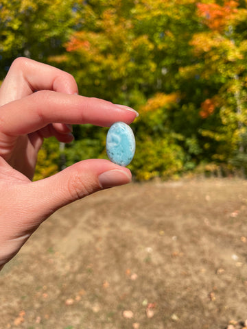 Light blue with soft white lines, Oval in shape with polished surface. It has effects on four of the seven Chakras