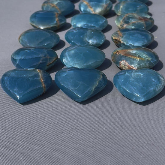 In this video, Lemurian Calcite gemstones - hearts, moons, frogs - smooth, pastel hues