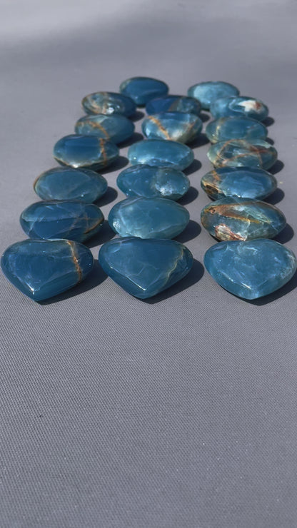 In this video, Lemurian Calcite gemstones - hearts, moons, frogs - smooth, pastel hues