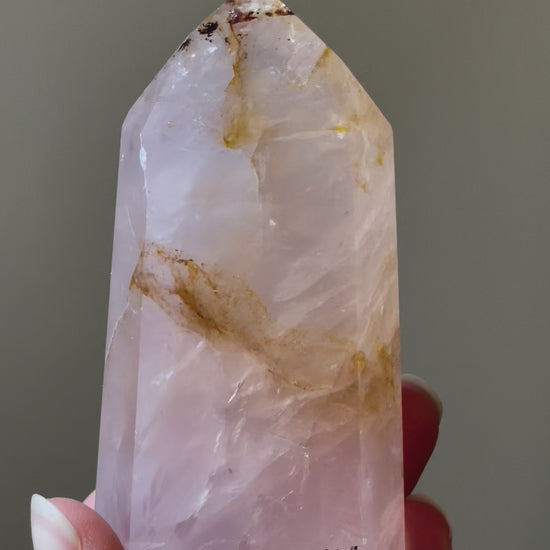 In this video, Elegant Rose Quartz tower, featuring soft pink tones, with golden healer and a graceful crystal formation for a serene and enchanting aesthetic